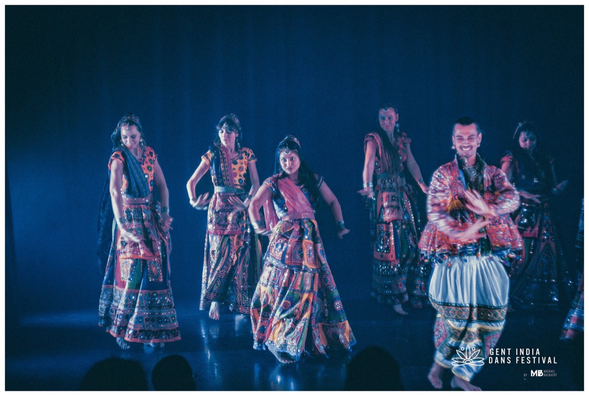 ABC company Garba ensemble mid-performance in mirrored costumes