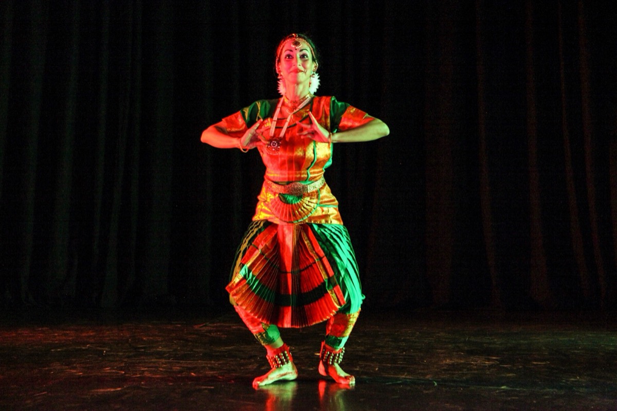 Guest artist holding a mudra mid-turn at the GIDF Gala