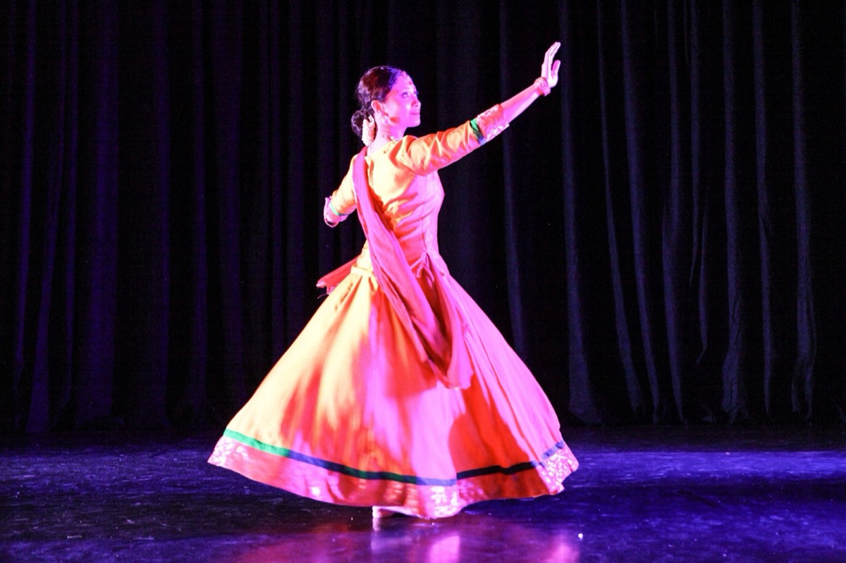 Guest artist mid-reach in a peach anarkali at the GIDF Gala