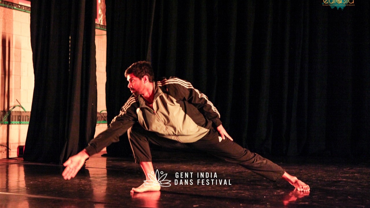 Girish Kumar in a deep lunge under warm light