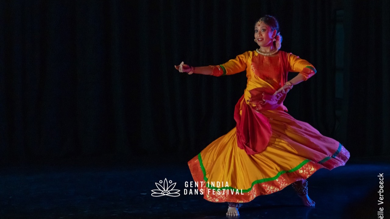 Shreyashee Nag in orange and gold, mid-spin with skirt open