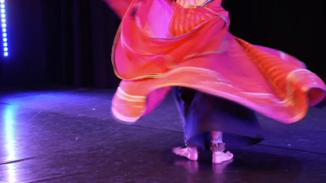 Colleena Shakti mid-spin, skirt opened into a full circle