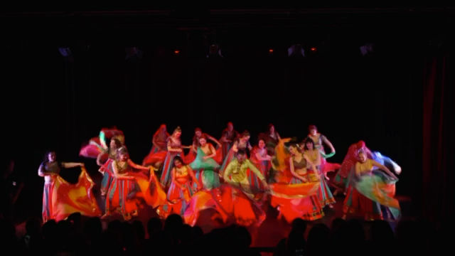 Dancers spinning, skirts opened into full circles